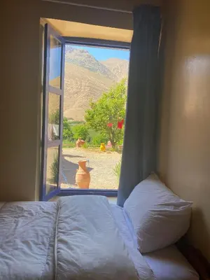 a bed in front of a window with a view at Gîte Imarin in Agouti
