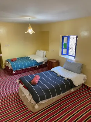 a bedroom with two beds and a window at Gîte Imarin in Agouti