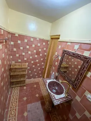 a bathroom with a sink and a mirror at Gîte Imarin in Agouti