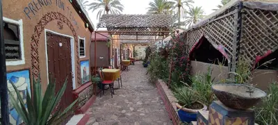 an alley with some plants and some buildings at Prends Ton Temps in Zagora