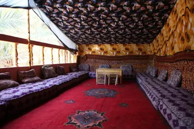 a room with couches and a table in a tent at Prends Ton Temps in Zagora