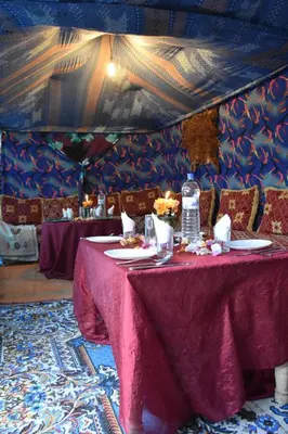 a dining room with a table with a purple table cloth at Prends Ton Temps in Zagora