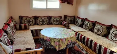 a living room with a couch with a table at Groupe appart-La casa de Wael in Ifrane