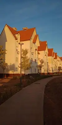 a row of large white buildings with red roofs at Groupe appart-La casa de Wael in Ifrane