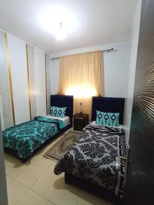 a bedroom with two beds and a window at Groupe appart-La casa de Wael in Ifrane
