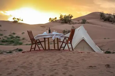 a table and chairs in the sand in the desert at Exclusive 