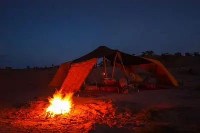 a tent with a fire in front of it at night at Exclusive 