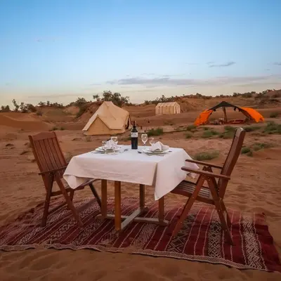 a table and two chairs and a tent in the desert at Exclusive 