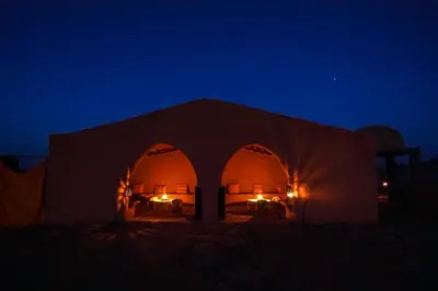 a tent in the desert at night at Rêve du Sahara - Dar Azawad Desert Camp in Mhamid