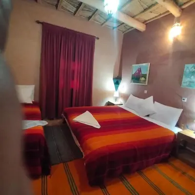 a bedroom with two beds in a room at Kasbah ben Ali in Kalaat MGouna