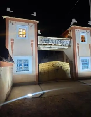 a building with a garage with a sign on it at Kasbah ben Ali in Kalaat MGouna