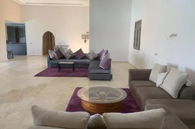 a living room with couches and a coffee table at Villa ChezMoi in Oulad Tayeb