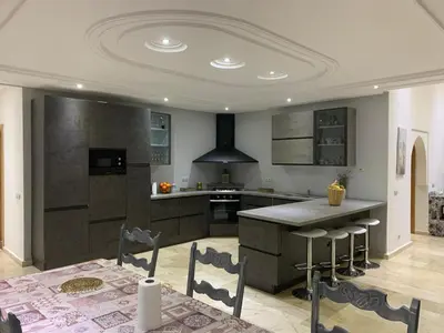 a kitchen with a table and a stove top oven at Villa ChezMoi in Oulad Tayeb