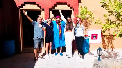 a group of people standing in front of a building at Kasbah Tussna in Boumalne