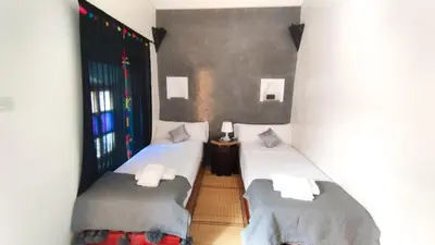 two twin beds in a room with at Kasbah Tussna in Boumalne
