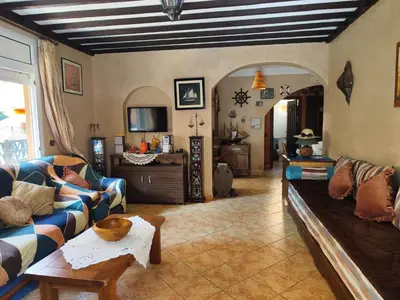 a living room with a couch and a table at Appartement high standing piscine jardin mer proche Mohammedia in Figuiq