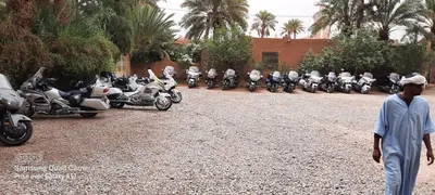 a group of motorcycles parked in a parking lot at Paradise in the southern desert Morocco in Tamegroute