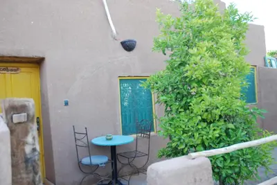 a patio with a table and chairs next to a building at Paradise in the southern desert Morocco in Tamegroute