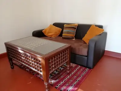 a living room with a couch and a coffee table at Riad Darga Rouge in Marrakech