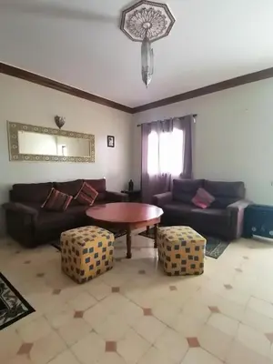 a living room with a couch and a table at Riad Darga Rouge in Marrakech