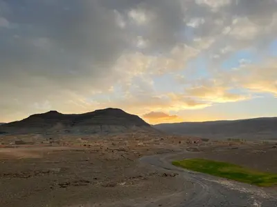 a dirt road in the middle of a desert with mountains at Auberge & Restaurant Agoudal in Agoudal