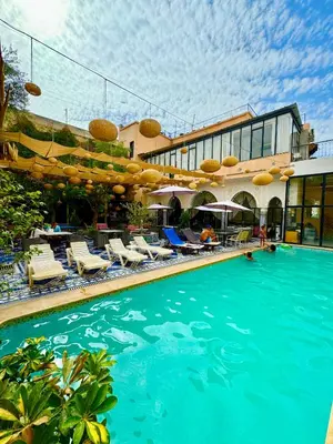 a swimming pool in front of a hotel at Palais Shazam & SPA in Fès