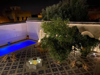 an overhead view of a patio with a tree and a pool at Palais Shazam & SPA in Fès