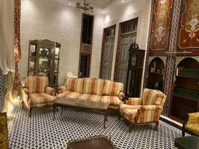 a living room with two chairs and a couch at Palais Shazam & SPA in Fès