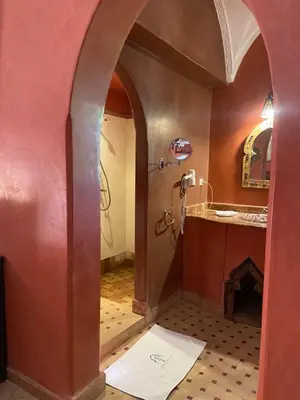 a bathroom with a sink and a shower in a room at LES JARDINS DE MARRAKECH in Marrakech