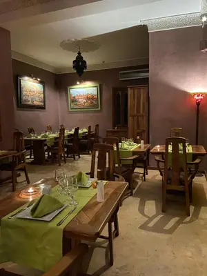 a dining room with wooden tables and chairs at LES JARDINS DE MARRAKECH in Marrakech