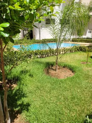 a yard with two trees and a swimming pool at Luxury apart in Fes monumental Exclusively for the family in Fès