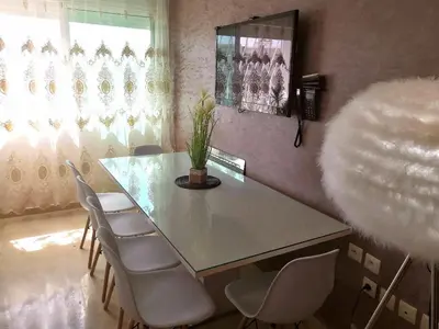 a dining room with a glass table and chairs at Luxury apart in Fes monumental Exclusively for the family in Fès