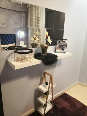 a room with a shelf with vases and a table at Luxury apart in Fes monumental Exclusively for the family in Fès