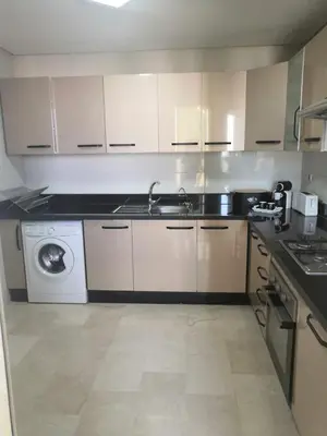 a kitchen with a sink and a washing machine at Luxury apart in Fes monumental Exclusively for the family in Fès