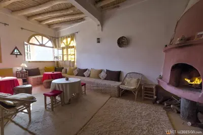 a living room with a couch and a fireplace at Kasbah Agoulzi in Kalaat MGouna