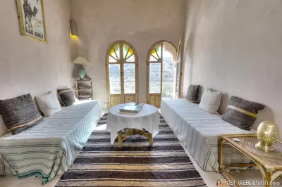 a living room with two couches and a table at Kasbah Agoulzi in Kalaat MGouna