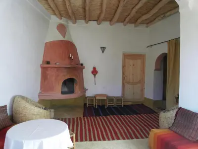 a living room with a pizza oven in a house at Kasbah Agoulzi in Kalaat MGouna