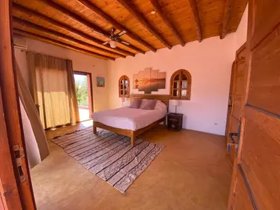 a bedroom with a bed and a large window at Villa sur le lac Bin el ouidane in Aït Irizane