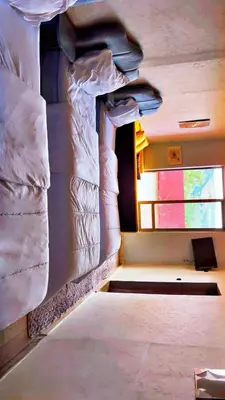 a room with a bed and a rock wall at Hotel France Ouzoud in Ouzoud