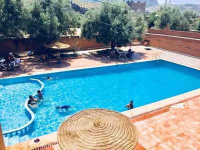an overhead view of a swimming pool with people in it at Hotel France Ouzoud in Ouzoud