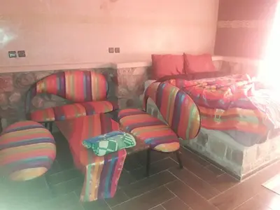 a room with two chairs and a bed and a couch at Hotel France Ouzoud in Ouzoud