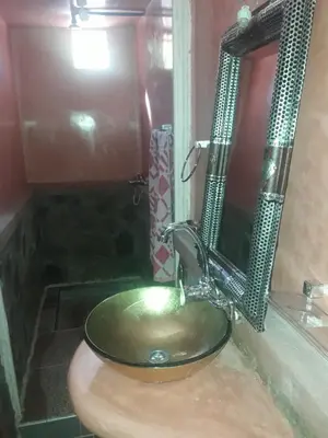 a bathroom with a green sink and a mirror at Hotel France Ouzoud in Ouzoud