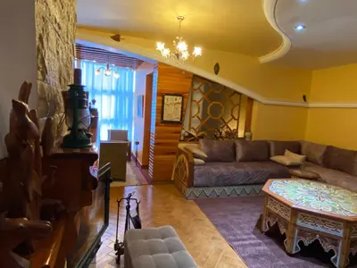 a living room with a couch and a table at Très joli appartement au centre de IFRANE in Ifrane