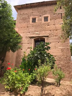 a stone building with plants in front of it at Kasbah Timdaf in Demnat