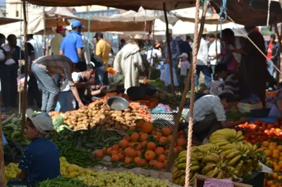 a group of people at a market with fruits and vegetables at Kasbah Timdaf in Demnat