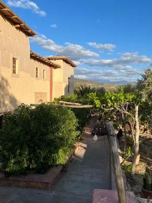 a house with bushes and a walkway next to a building at Kasbah Timdaf in Demnat