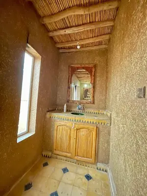 a bathroom with a sink and a mirror at Chegaga Starlight Camp - Mhamid Desert Haven in Mhamid