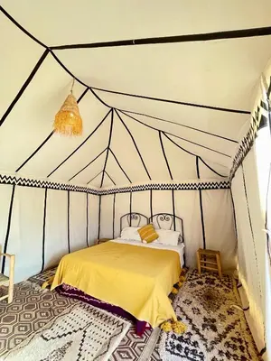 a bedroom with a bed in a tent at Chegaga Starlight Camp - Mhamid Desert Haven in Mhamid