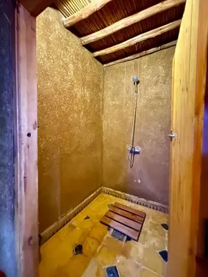 a room with a shower and a tiled floor at Chegaga Starlight Camp - Mhamid Desert Haven in Mhamid