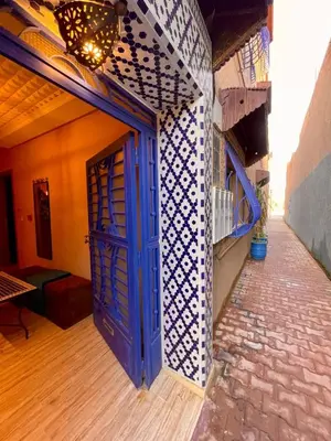 a blue door on the side of a building at Merzouga Hotel Lexpert 